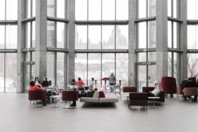 Office lobby with sofas and large windows.